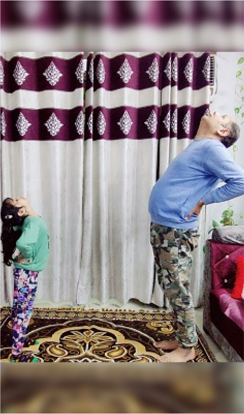 A person and a child doing yoga indoors