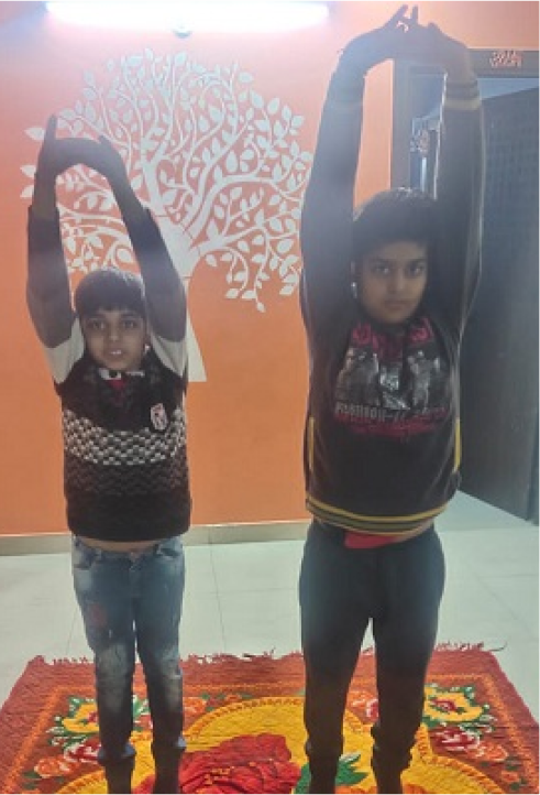 Two people doing yoga together indoors